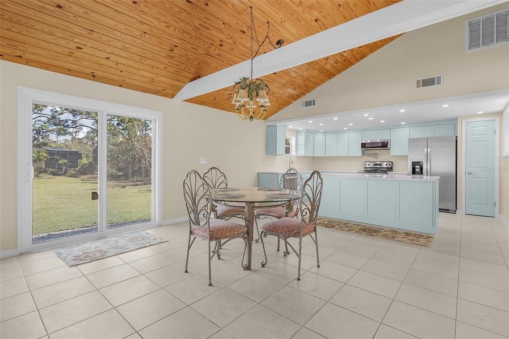 Open dining, living and kitchen concept with vaulted ceilings and beautiful beams