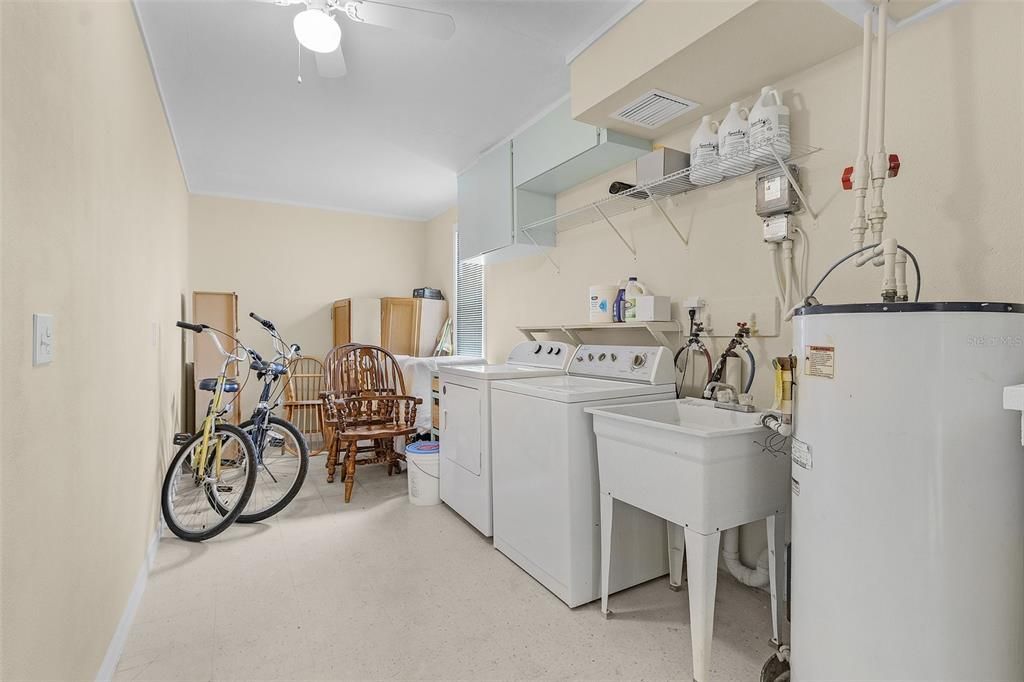 Laundry storage utility area. Cabinets at the end will be left with the home. Just hang them on the wall for additional storage!