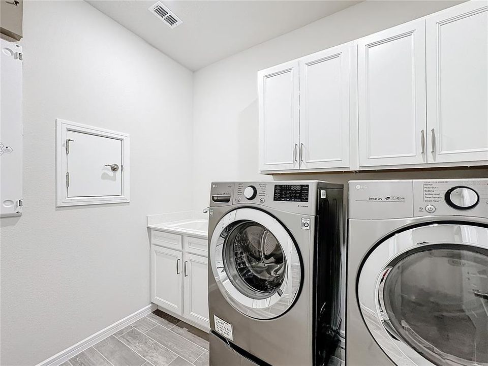 upgraded laundry additional storage, sink & quick drop laundry chute from master bath