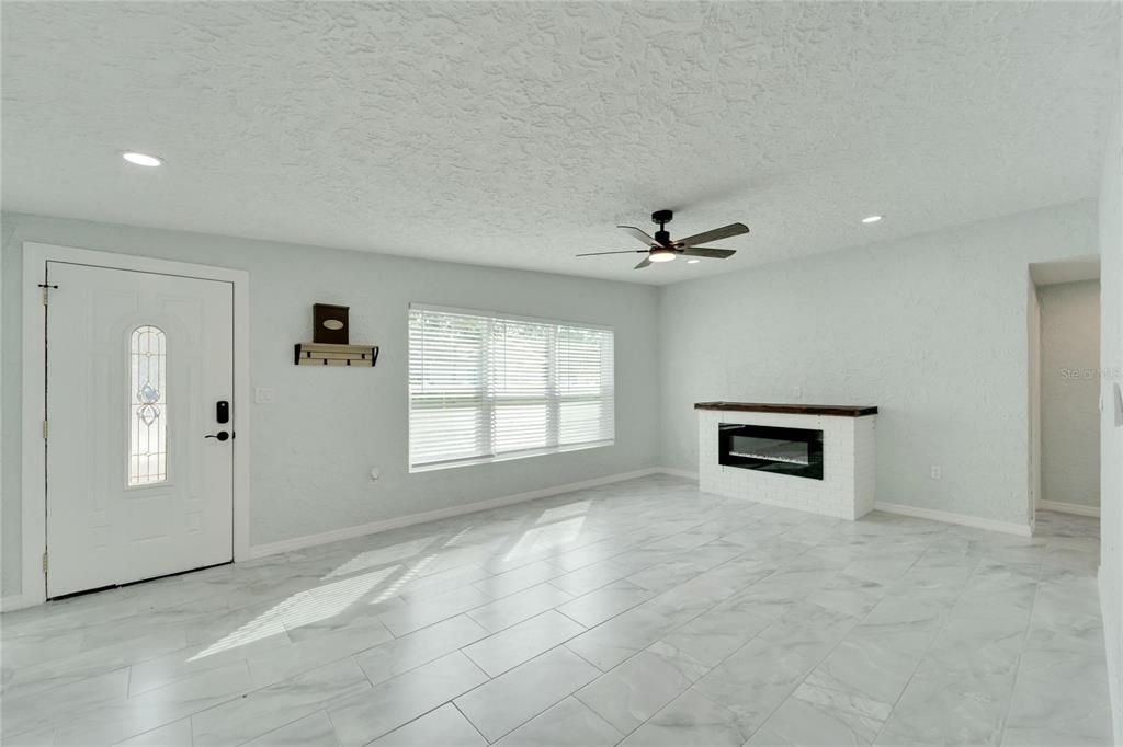 Family room with electric fireplace.