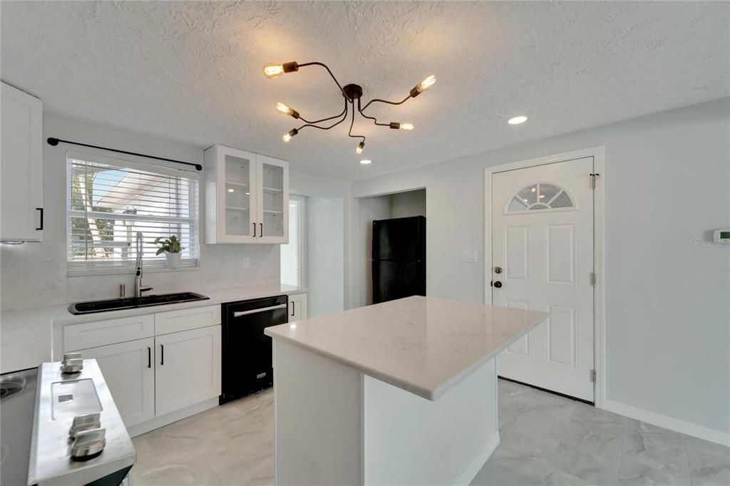 Kitchen with stainless steel appliances and ceramic countertops.