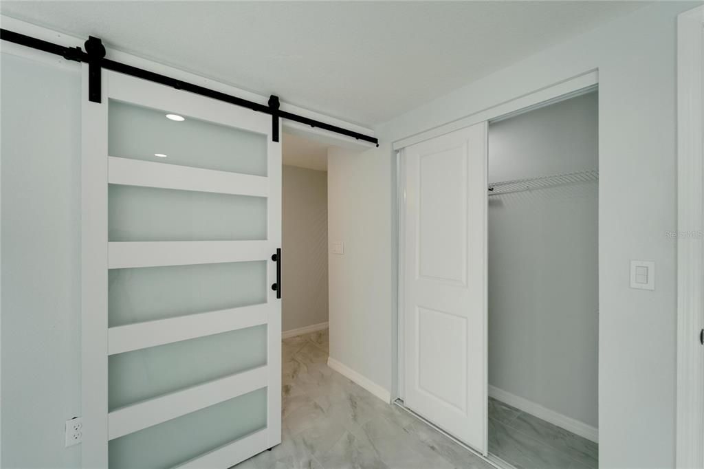 Barn door entry to master bathroom / laundry room.