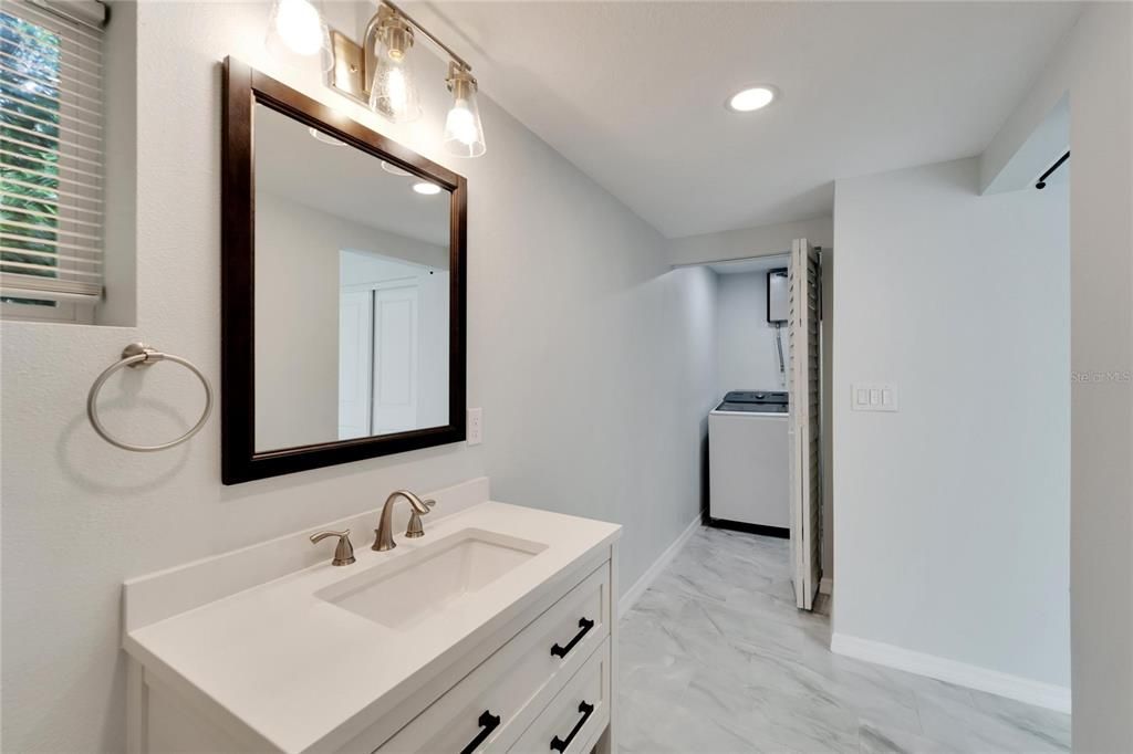 Master bath with view to laundry room.