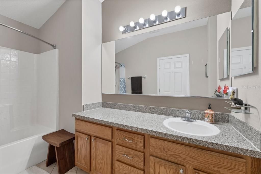 Owners suite bathroom featuring a large vanity, and alcove tub.