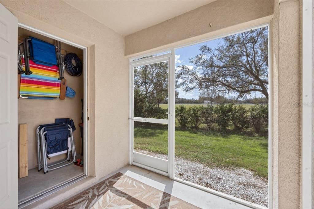 Covered Screened-in Lanai with views of your semi-private back yard and a large storage closet.