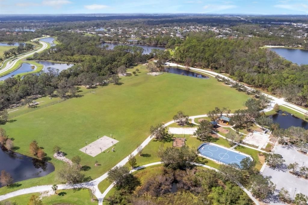 Aerial of Greenbrook Adventure park featuring the hockey rink, basketball courts, play ground, and sports fields.