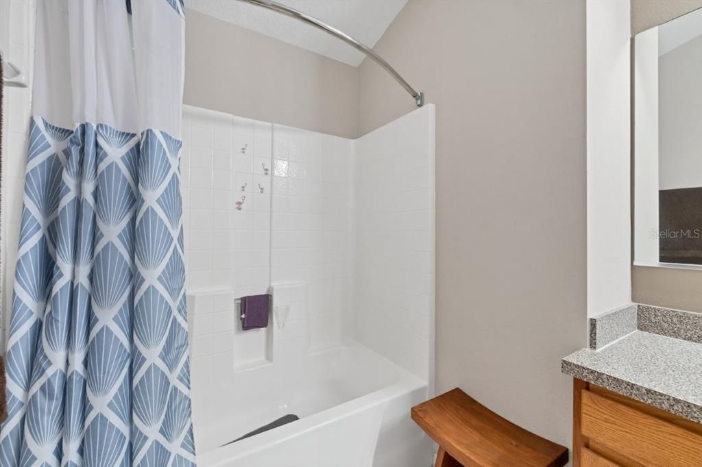 Owners suite bathroom featuring a large vanity, and alcove tub.