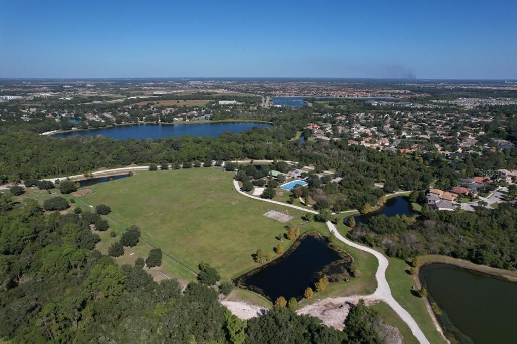 Aerial of Greenbrook Adventure park featuring the hockey rink, basketball courts, play ground, and sports fields.