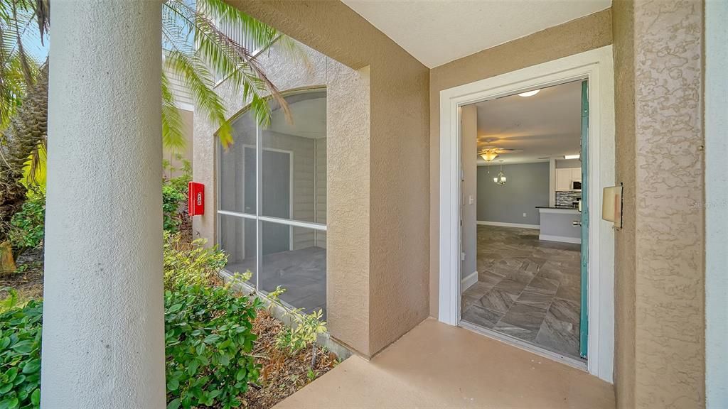 Front door with screened in patio to left