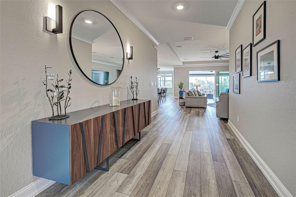 What a wonderful view - wide entryway, waterproof, luxury vinyl plank flooring and unique, luxury chandelier set the stage for this fabulous home.