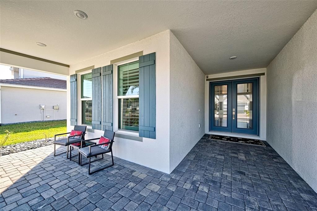 Charming front porch and elegant door, glass doors welcome you to this exquisite home.