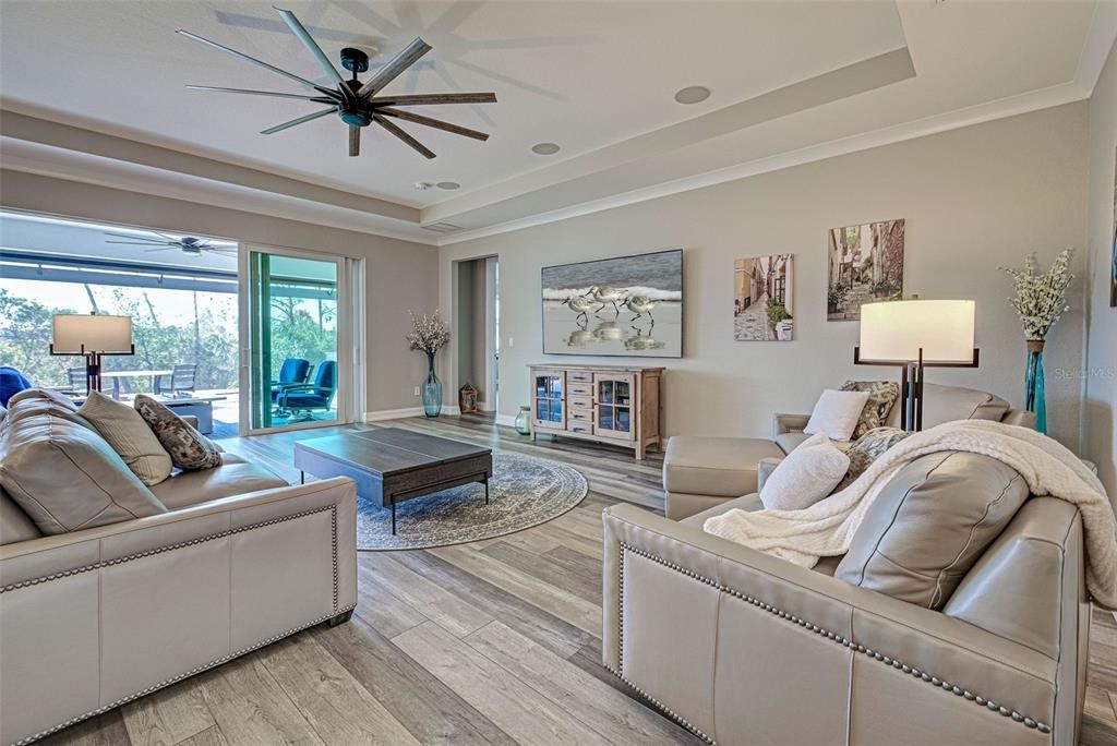 Great room is so light and bright thanks to the many windows and impact lanai sliders which lead to the enormous, private lanai.