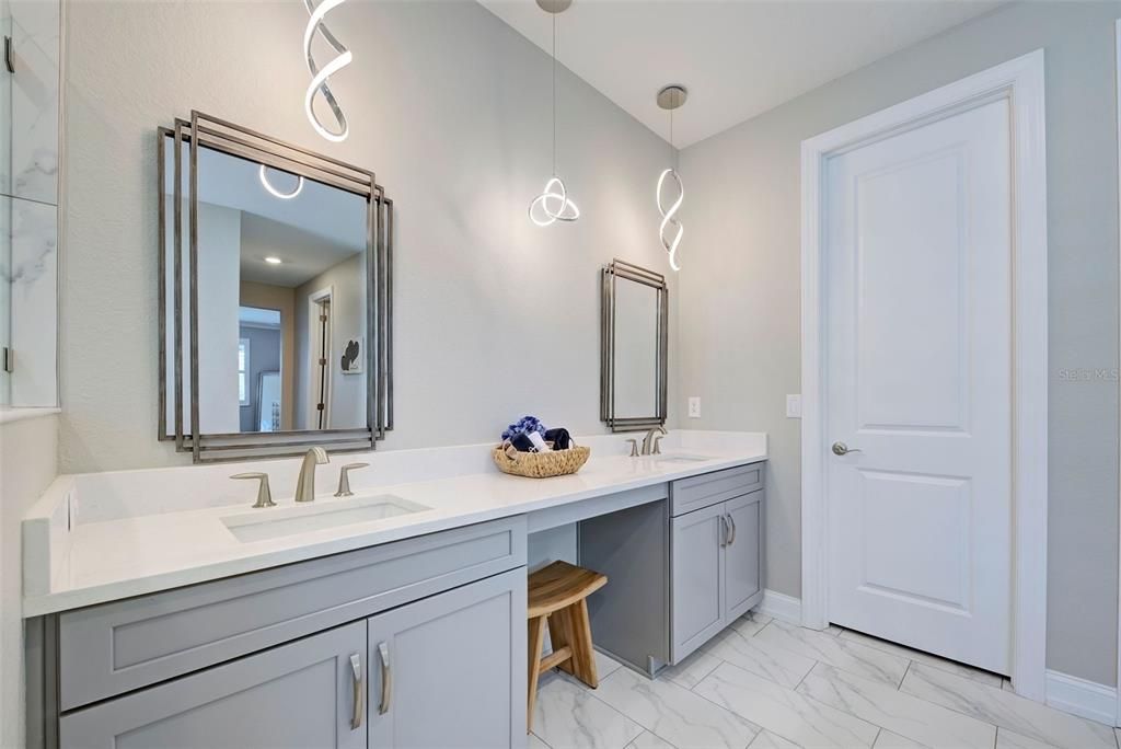 Primary bathroom with luxury lighting and mirrors - so classy.