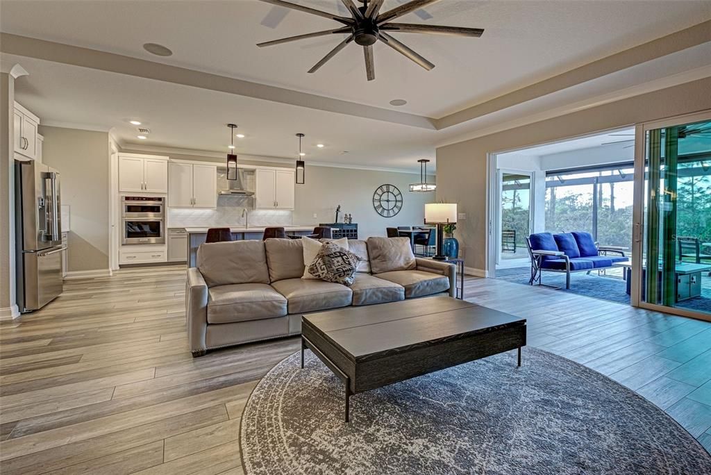 You will love entertaining or relaxing in the spacious great room with tray ceiling and classy crown molding which flows perfectly to the kitchen and lanai.  Trifold patio doors extend your living and entertaining space.