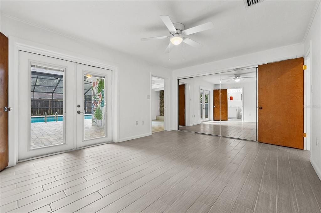 Primary Bedroom with doors to pool and bonus room