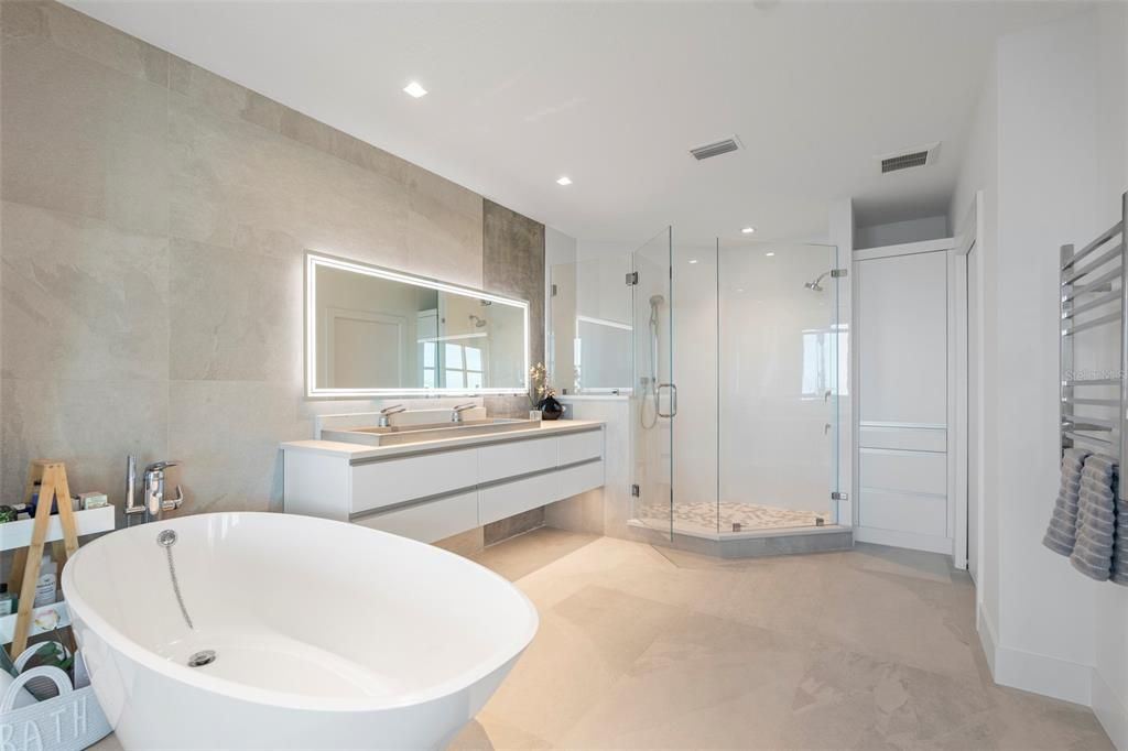 The primary bath is a spa-like retreat, complete with a Victoria + Albert soaking tub and walk-in shower