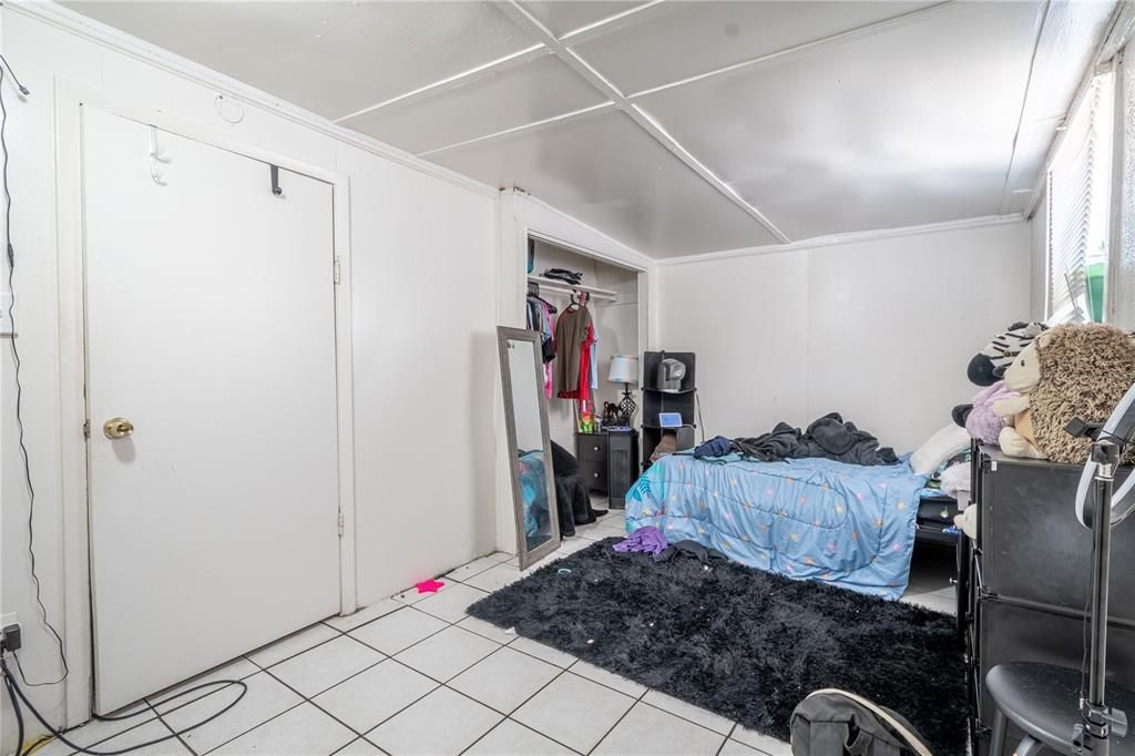 (Unit B) - Primary bedroom has ceramic tile floor and built in closet