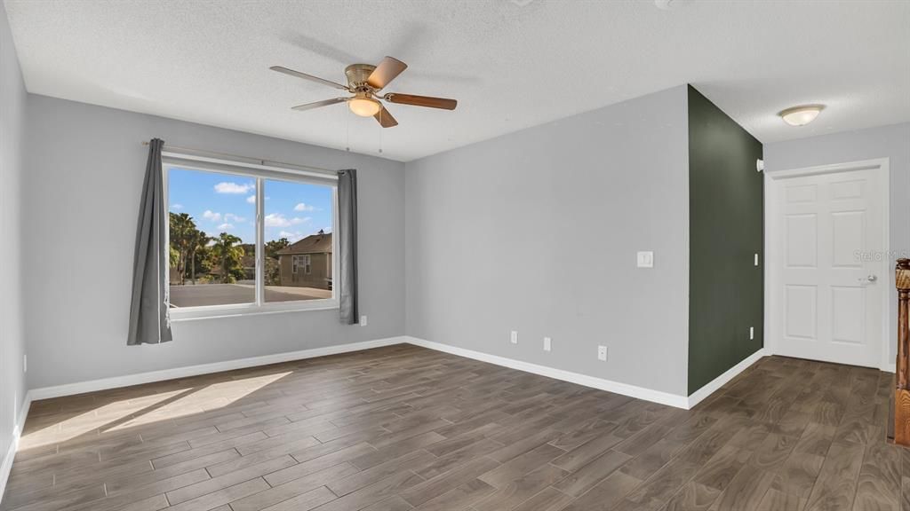 Loft area with new tile flooring and fan