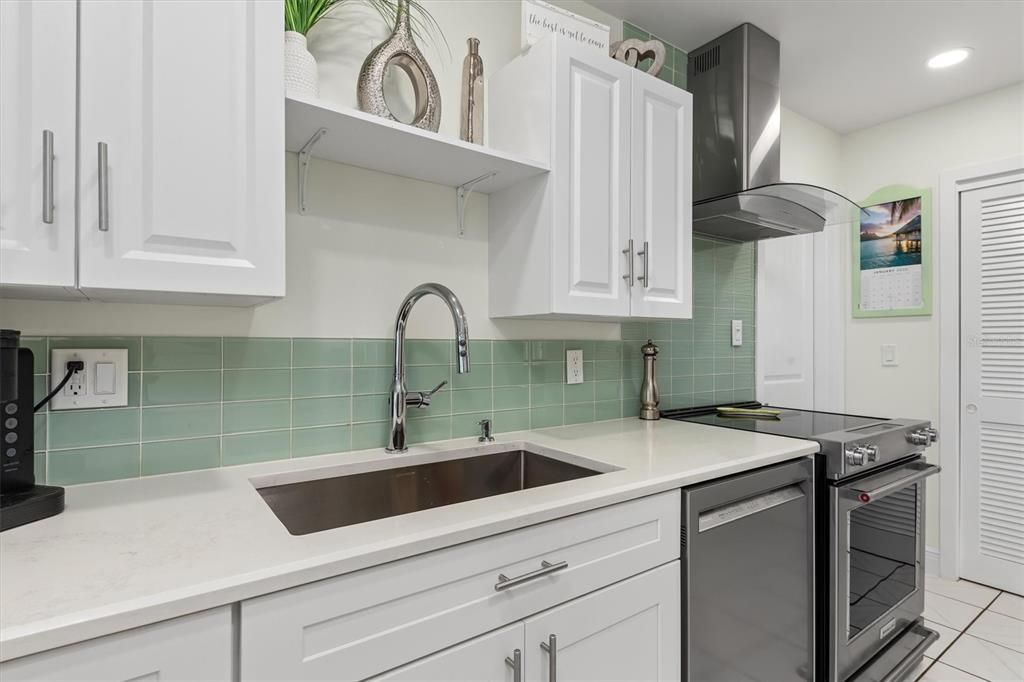 Large stainless-steel sink and large closet pantry are just two special features of this well-equipped kitchen.