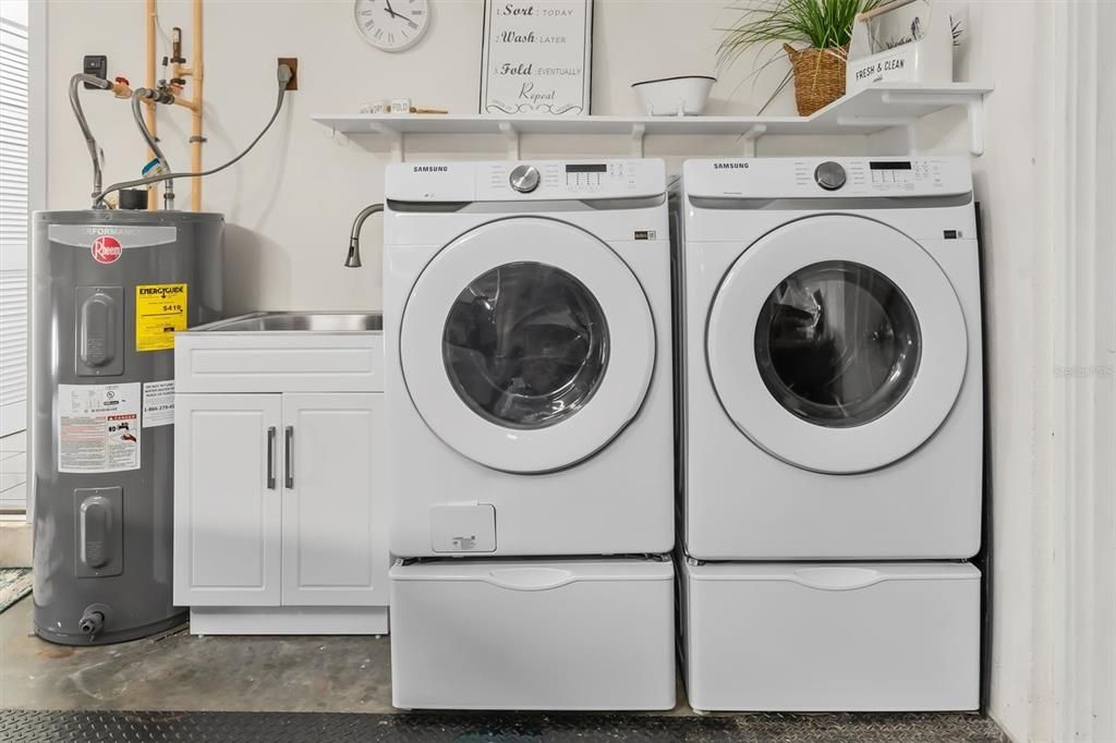 New washer and dryer conveys with home. Enclosed utility sink is convenient and practical.