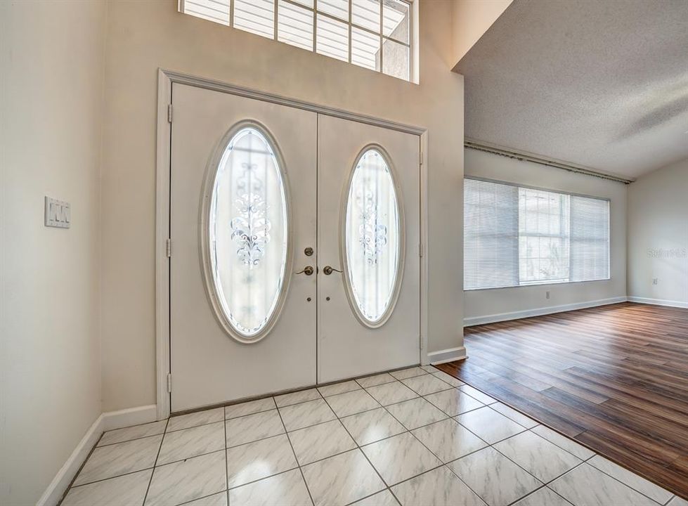 Stunning etched glass double doors grace the entry foyer. Double screen doors allow you to open the front doors and let the fresh breezes flow through.