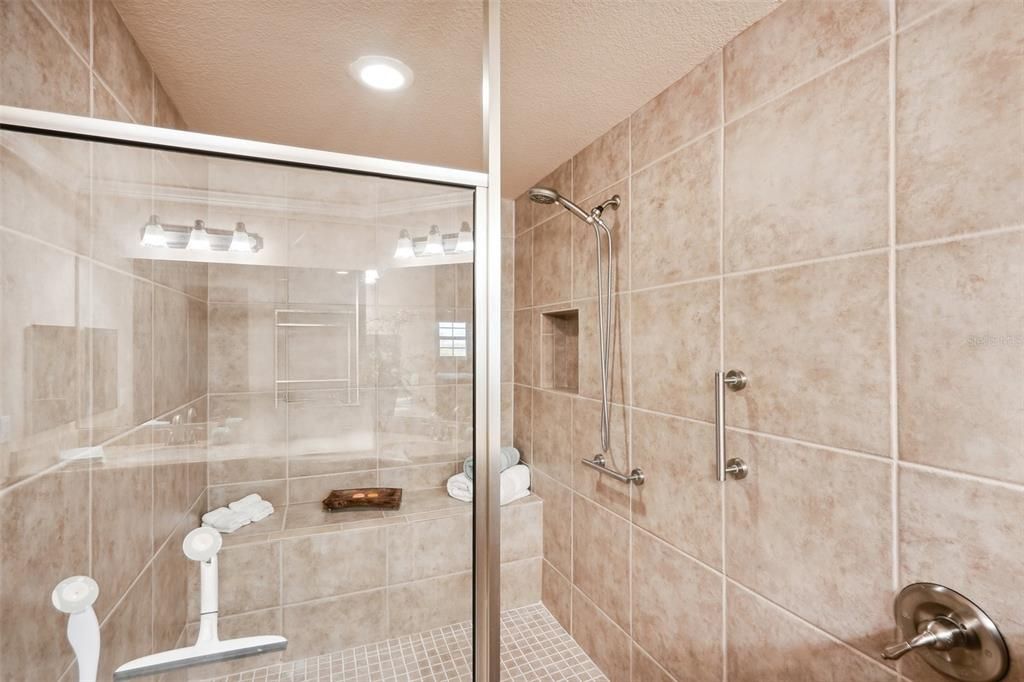 Oversized walk-in shower with grab bars for stability