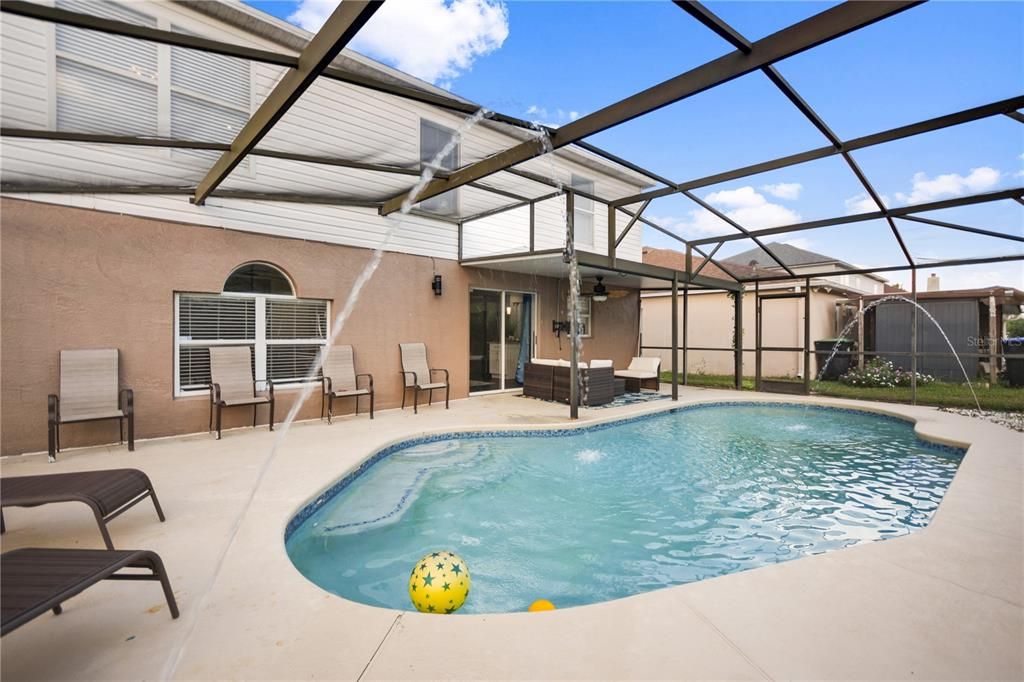 View of the back of the home and pool