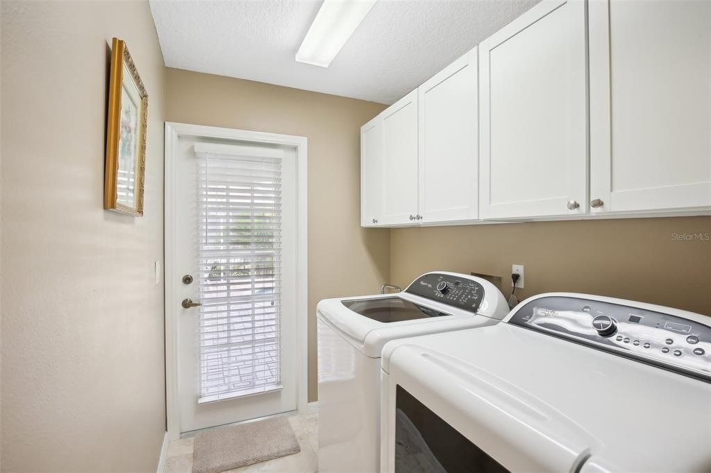 2nd bathroom with laundry room and lanai door to pool