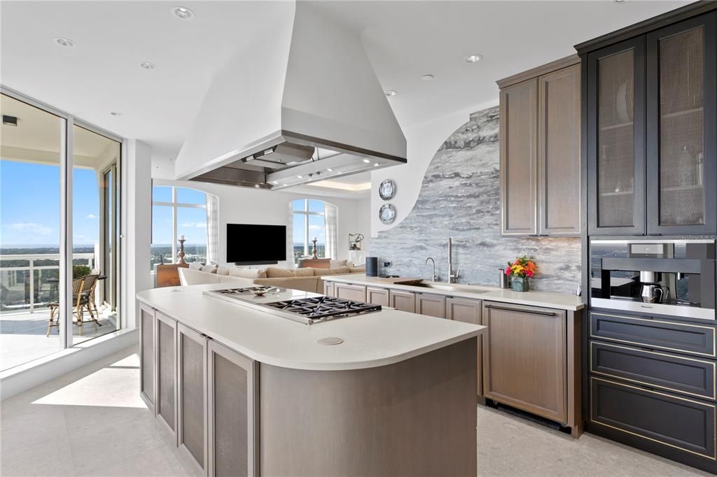 Kitchen Island with Wolf gas French Top 6-burner Cooktop and pop up electrical outlets on the island