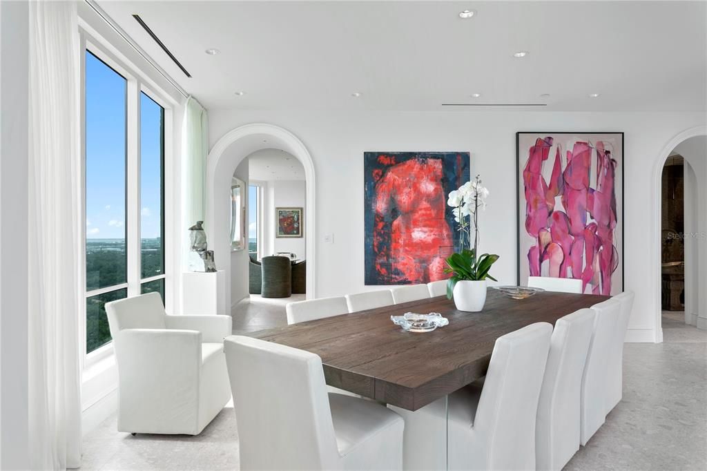 Dining room adjacent to the living room with south and east water views