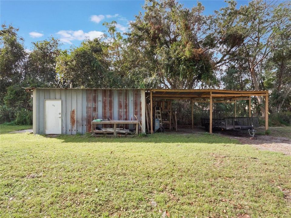 Approximately 10x15 storage building with additional carport storage