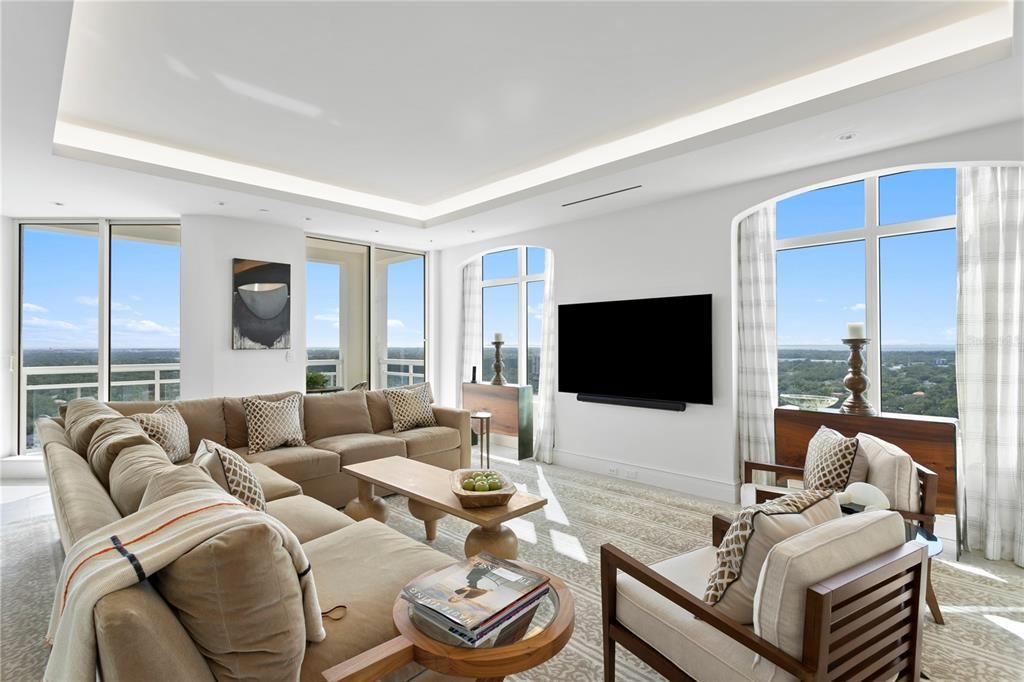 Family room loaded with windows showing off western and southern views to the St. Peterburg skyline