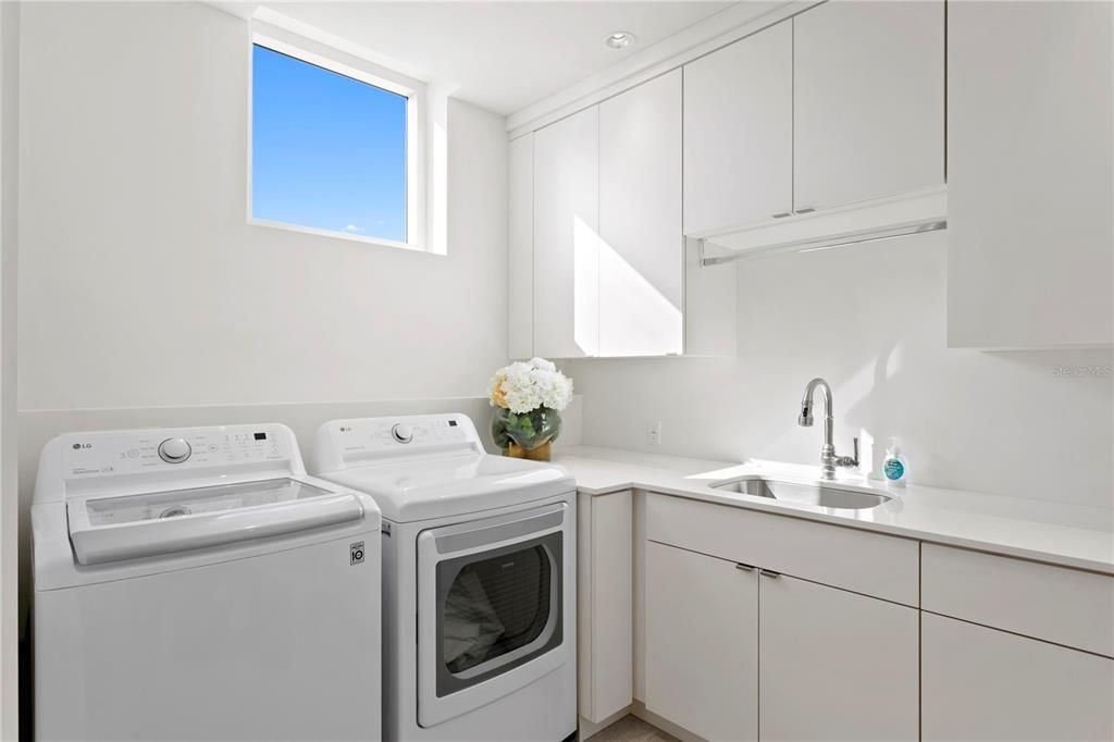 Laundry room with LG washer/dryer and built in drying rack and ironing board