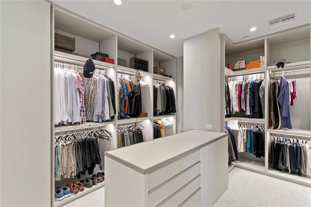 Primary Suite Walk- In closet with clothing pass through to the laundry room