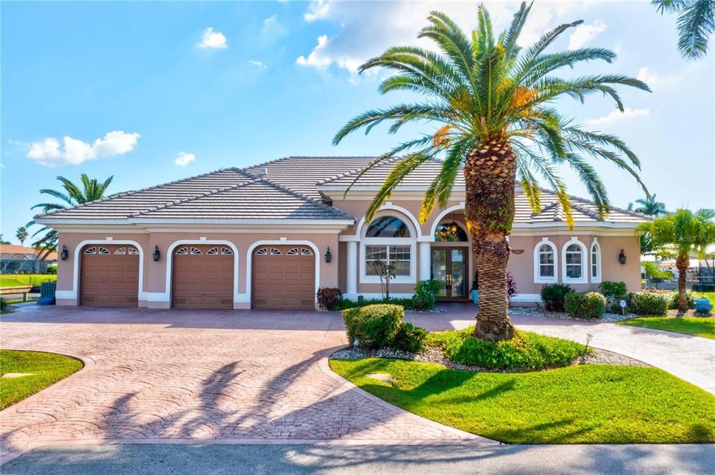 WELCOME to PARADISE! Everything about this home is perfect - the location at the end of a culdesac, on the corner of intersecting canals, southern exposure and extended paved driveway with plenty room for parking multiple vehicles. Lush and mature landscaping with beautiful brand new roof - this really has it all!