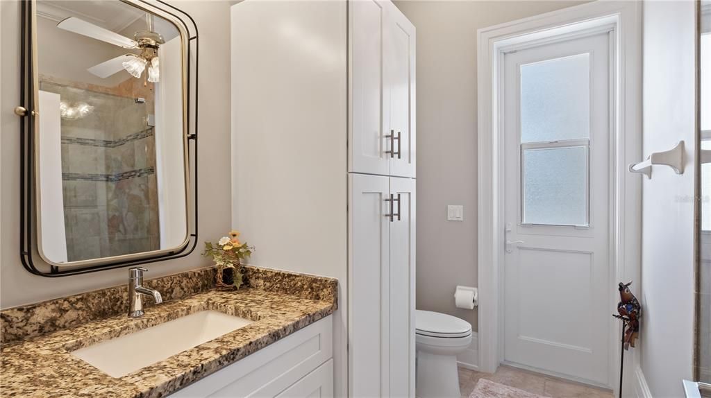 Full size guest bathroom with dual use as a pool bath. There are two additional half baths for guest use as well!