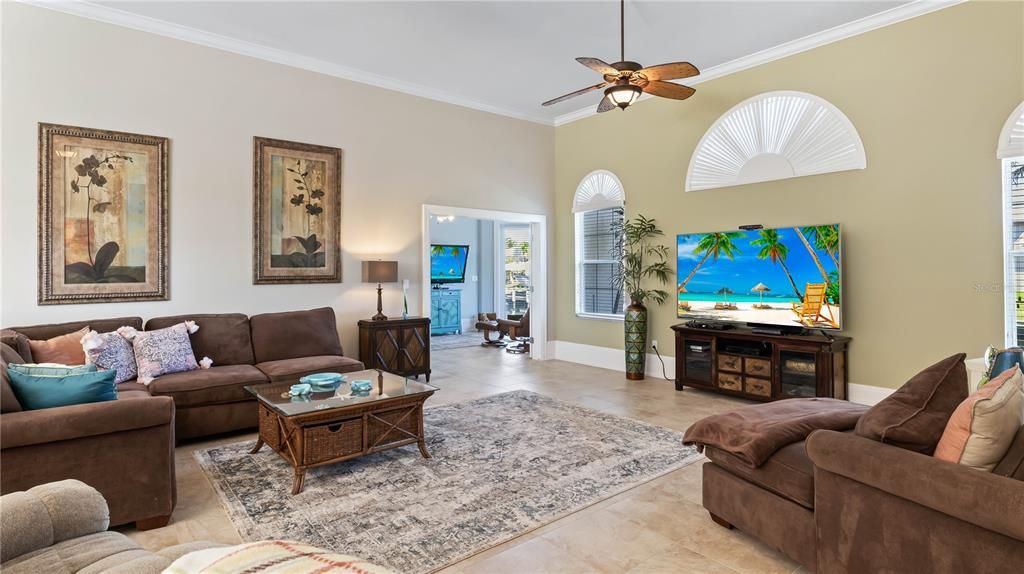 Family room looking into the media room with its own private entrance - travertine tile and an accent wall create a neutral and peaceful ambiance! Every inch was used to create a large, functional yet fun living space! Over 3,200 square feet and even a HIDDEN SAFE ROOM/HURRICANE ROOM - can you guess where it may be?