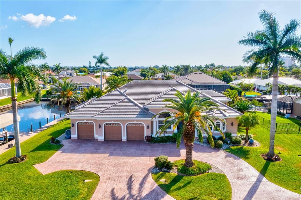 Aerial view of the home with boat lift and beautiful intersecting canals.