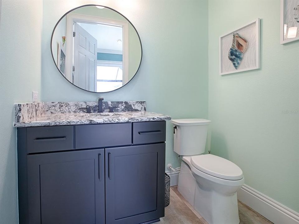 HALF BATH WITH GRANITE COUNTERTOPS.