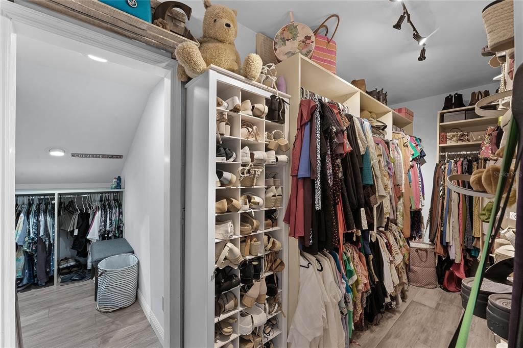 View of the wardrobe closet with plenty of shelving and storage space.