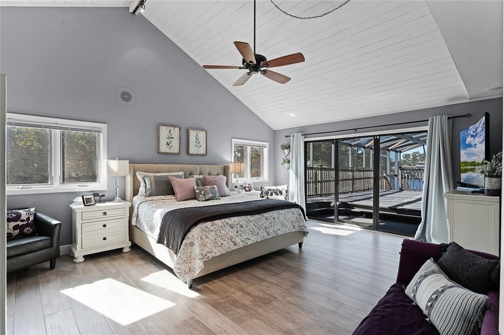 View of the master bedroom and sliding doors that connect to the balcony.