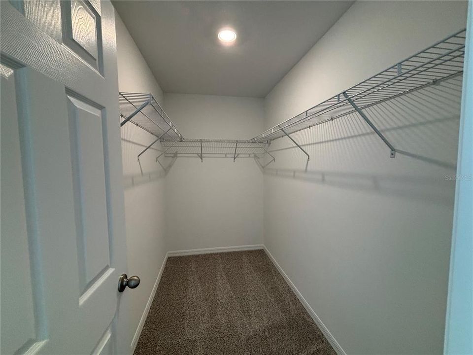 Primary bedroom walk in closet