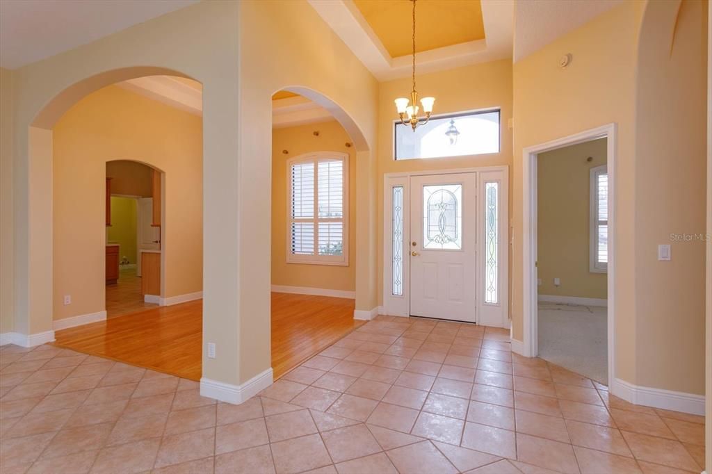 Lead glass front door and step ceiling in the foyer