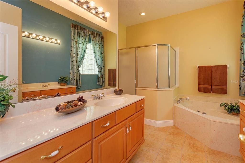 Primary bathroom with dual cultured marble vanities