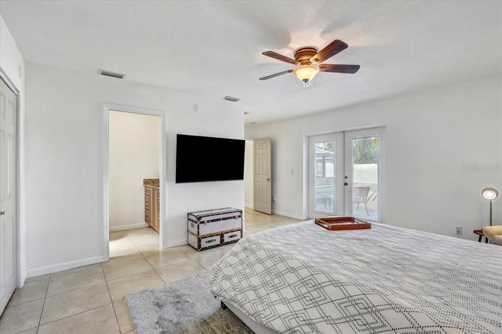 Primary suite (bedroom #6) with double door out to the pool