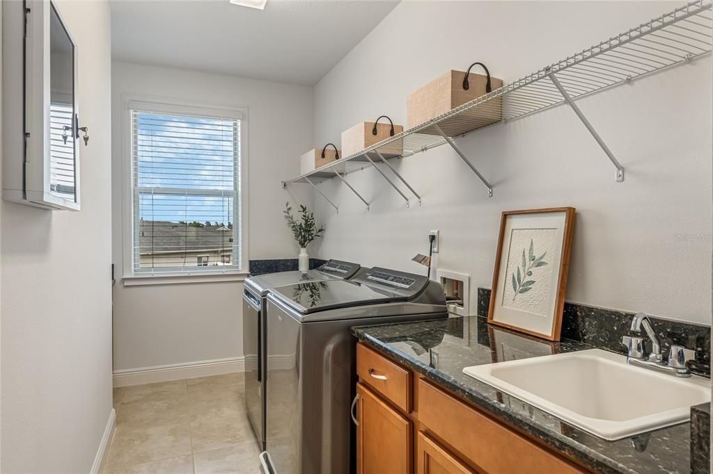 Laundry Room with tons of Storage and Utility sink, as well as granite countertops