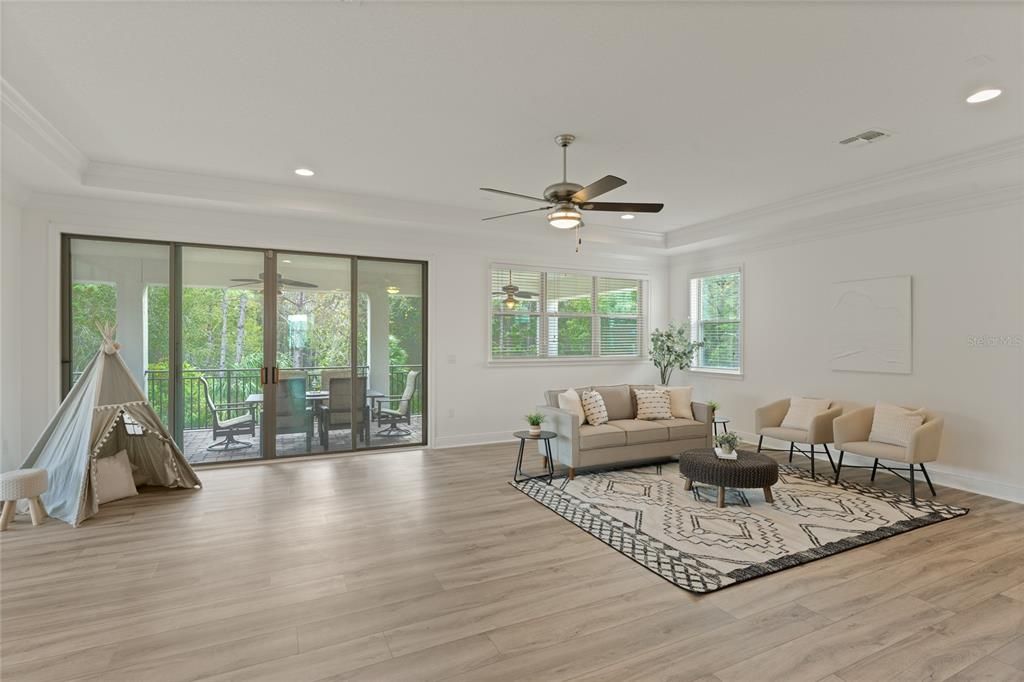 Loft has tray ceiling with recessed lights and LVP flooring