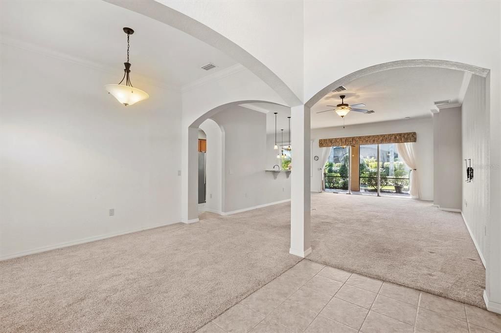 Main entry looking through home. Formal Dining on left, private den on right, living room ahead, master on right, other bedrooms on left behind kitchen