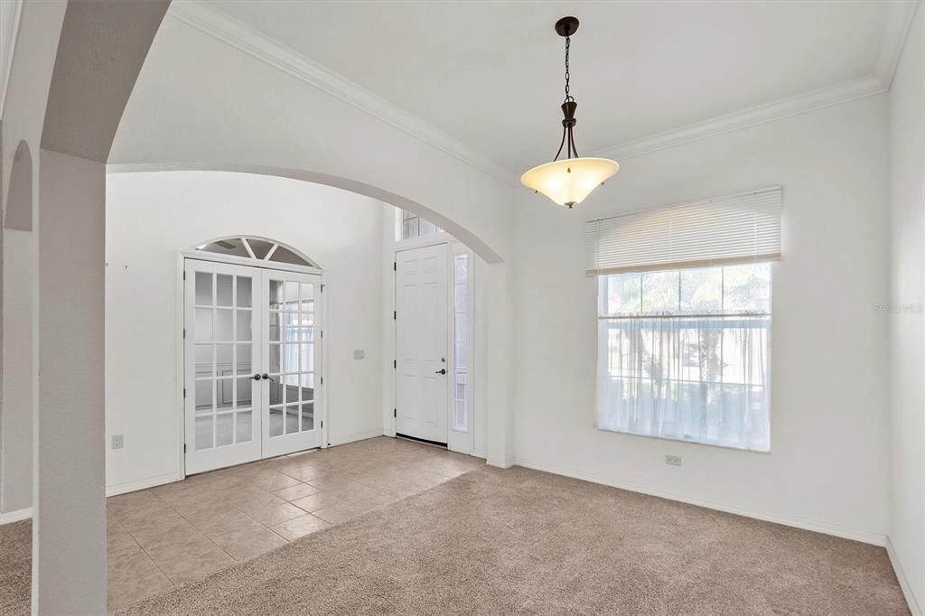 reverse formal dining looking at front entry door and private den