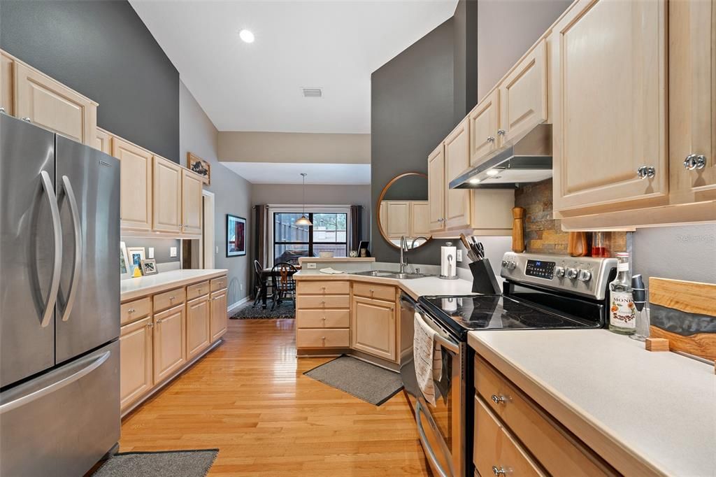 Kitchen feauturing hardwood flooring, large walk in pantry, stainless appliances